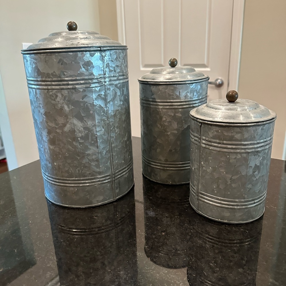 Set of three galvanized metal round tins with lids